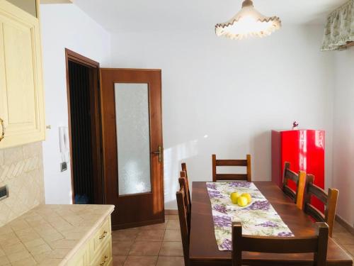 a kitchen with a table and a red refrigerator at Casa Eraclea Venice in Eraclea
