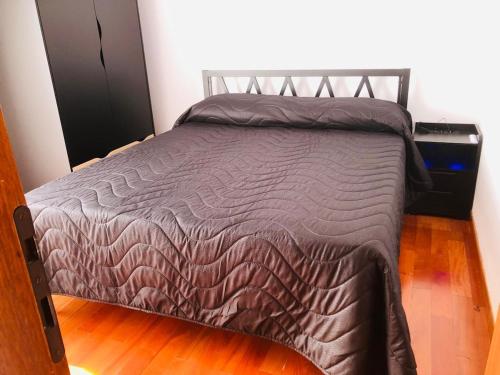 a bed with a brown comforter in a room at Casa Eraclea Venice in Eraclea