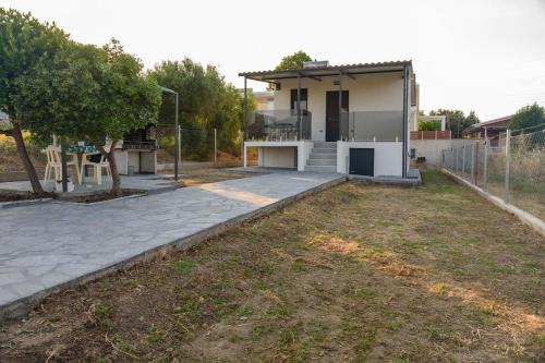 a house with a yard with a building at Oxygen Nest in Nea Kalikratia