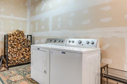 a kitchen with a stove and a pile of wood at 8 Mi to Staunton State Park Mtn-View Hideaway! in Conifer