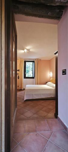 a bedroom with a bed and a window at Palazzo Cafarelli in Laureana Cilento