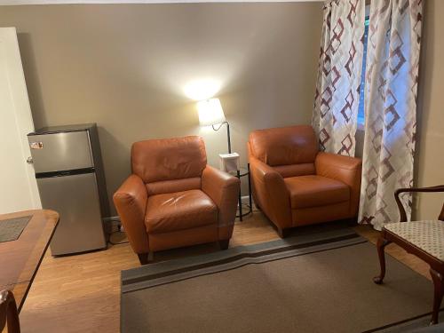 a waiting room with two chairs and a lamp at Convenient & Cozy Stay Near Boston in Andover