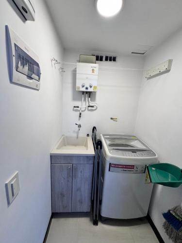 a small kitchen with a sink and a washing machine at 2211 Despierta en poblado Medellín - Vista panorámica in Medellín