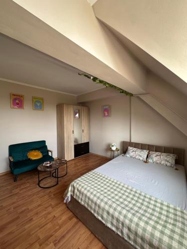 a bedroom with a large bed and a couch at Garsonieră lângă Prefectură in Craiova