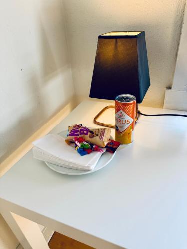 a table with a plate of food and a can of beer at RELAXED LIVING No 02 Historic Oslo in Oslo