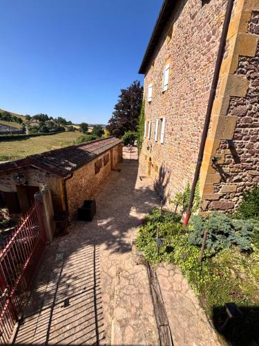 an empty alley next to a brick building at Gite de la Réserve in Coublanc
