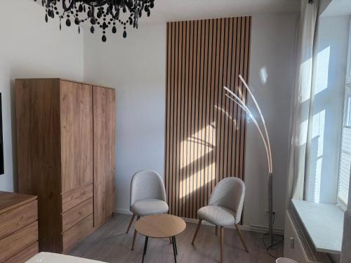 a living room with two chairs and a table at Haus Burmeister in Sassnitz