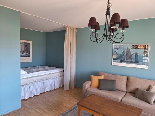 a living room with a couch and a bed at Mysiga 21 an in Mariehamn