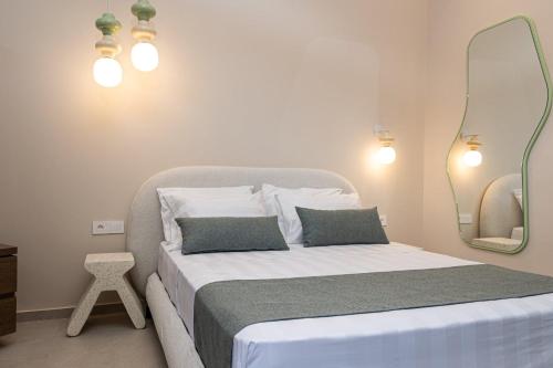 a bedroom with a bed with a mirror and lights at Madonna del Mare City in Chania Town