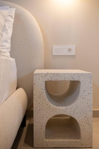 a side table with a bed and a couch at Madonna del Mare City in Chania Town