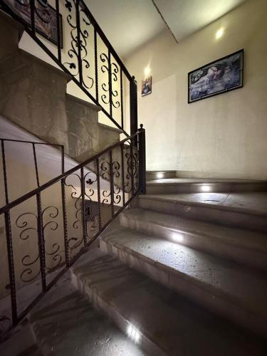 a set of stairs with a metal railing at Hotel Hacienda Tonalmain, Central Nueva in Guadalajara