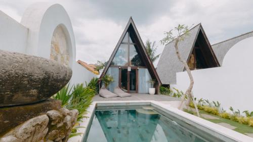 an external view of a house with a swimming pool at Private villa 1 bedrooms Kaba-kaba tabanan in Kapal