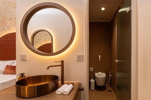 a bathroom with a copper sink and a mirror at Madonna del Mare City in Chania Town