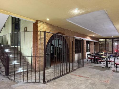 a wrought iron fence in front of a brick building at Hotel Hacienda Tonalmain, Central Nueva in Guadalajara