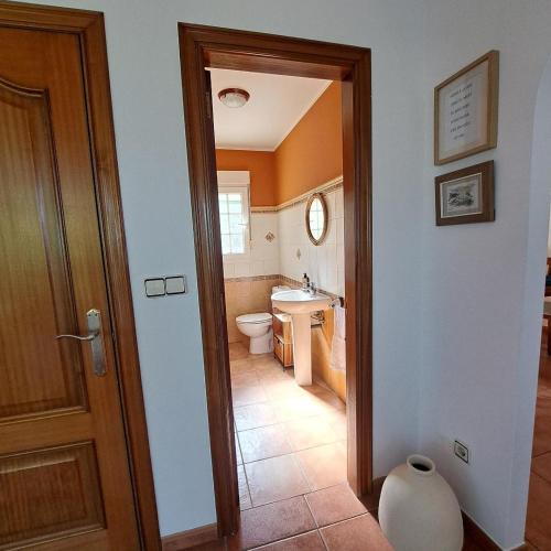 a bathroom with a toilet and a sink at Casa Teresa in Laxe