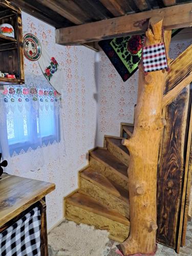 a set of stairs in a room with a tree at Casuta din padure in Breb