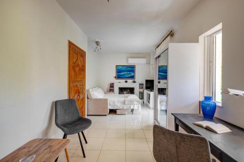 a living room with a bed and a table and chairs at Aura in Piraeus
