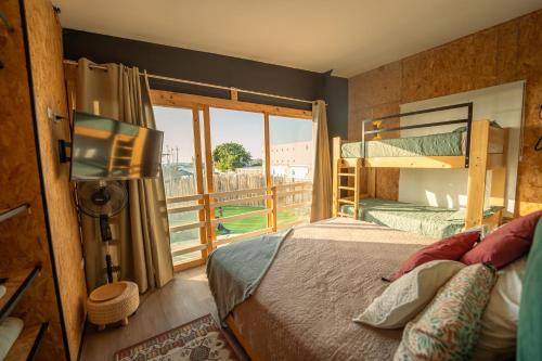 a bedroom with a bed and a large window at El Santuario Paracas in Paracas