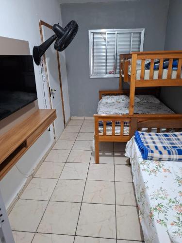 a room with two bunk beds and a tiled floor at AEROHOSTEL Brasil in Guarulhos