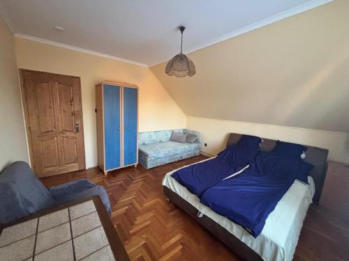 a bedroom with a bed and a couch at Missy House in Igricetanya