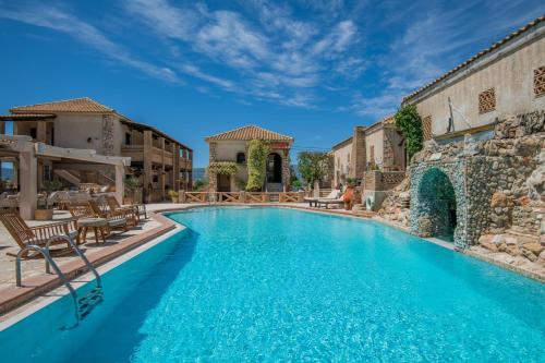 a large swimming pool with blue water at Garden Village Hotel in Kalamaki