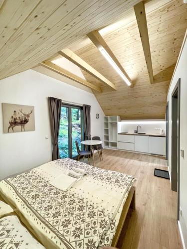 a bedroom with a bed and a table at Chalet La Martina in Zuberec