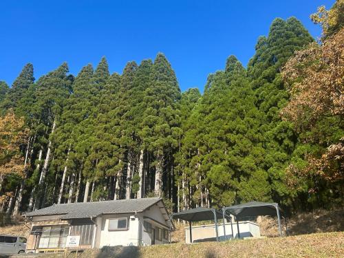 a house in front of a forest of trees at Potontoikkenya Kuraoka - Vacation STAY 23373v in Mamihara