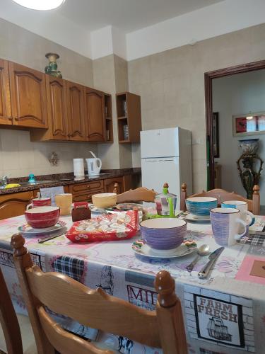 a kitchen with a table with dishes on it at Appartamento Isabella in Spotorno