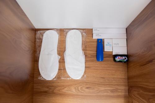 a pair of white shoes sitting on a wooden floor at Centrum Hotel Tashkent in Tashkent