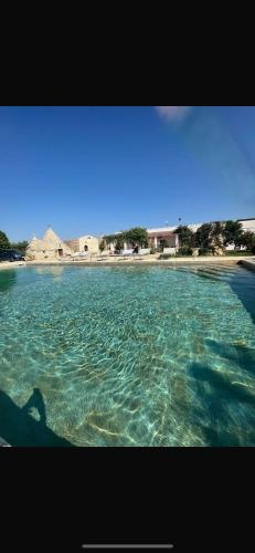 a large body of water with a beach in the background at Bed & breakfast vecchia vallata in Gioia del Colle