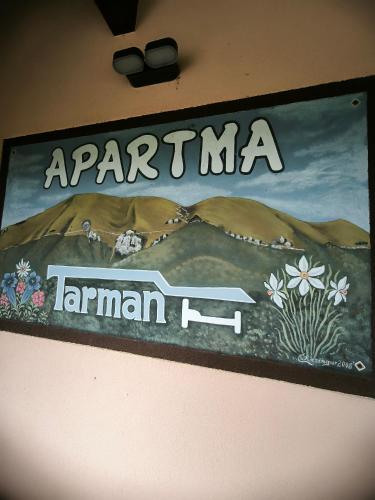 a sign on a wall with a picture of a desert at Apartment Tarman in Jesenice