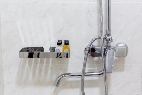 a bathroom with a shower with a faucet at Centrum Hotel Tashkent in Tashkent