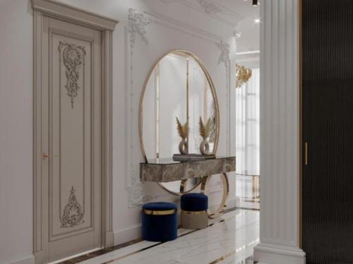 a hallway with a mirror and a console table at Luxary Home Flora inn in Baku