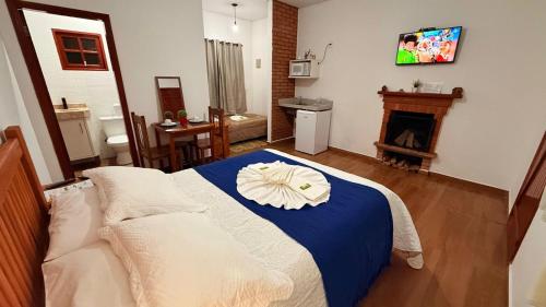 a bedroom with a bed with a flower on it at Chalés Raios de Sol in Monte Verde