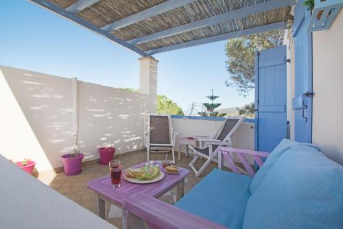 a patio with a table with a plate of fruit on it at Filoxenes Katoikies in Dhiakofti