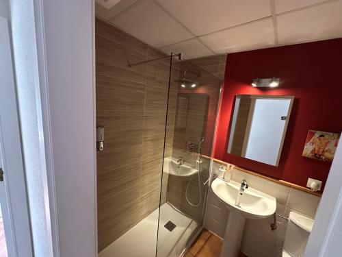 a bathroom with two sinks and a glass shower at En la zona más tranquila del Novo Sancti Petri in Chiclana de la Frontera