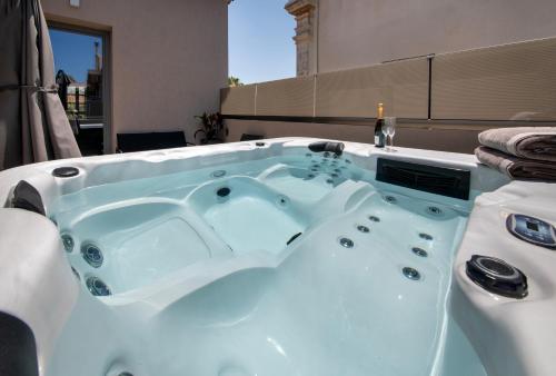 a jacuzzi tub in the middle of a room at Nearchou Boutique Hotel in Chania Town