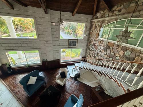 an overhead view of a room with a staircase and chairs at Casa De La O Yautepec in Yautepec