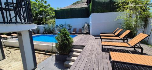 a patio with two chairs and a swimming pool at villa gardens in K'obulet'i