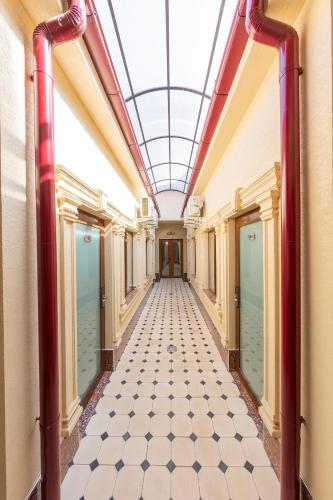 an empty corridor in a building with a glass ceiling at Centrum Hotel Tashkent in Tashkent