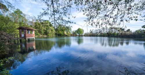 a river with a small building in the middle at Relais Del Lago in Capannori