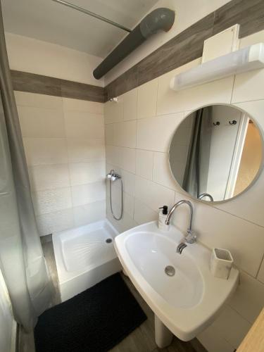 a bathroom with a sink and a mirror at Maison cosy avec cour privée - Calme et nature, La Trimouille in La Trimouille