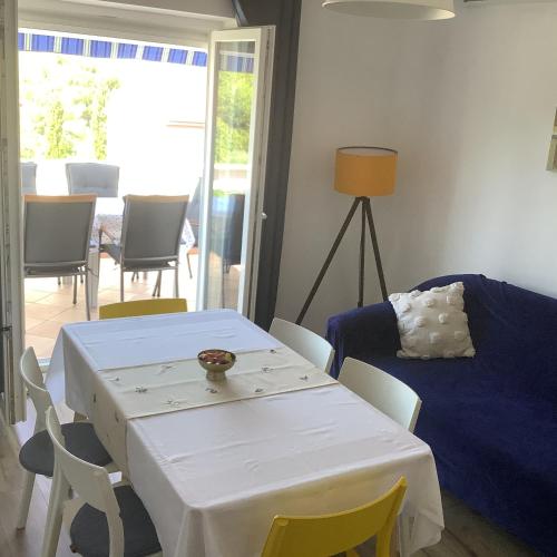 a living room with a white table and chairs at Apartment Vitezic in Punat