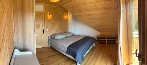 a bedroom with a bed in a small room at Cicha Ostoja in Czarny Dunajec
