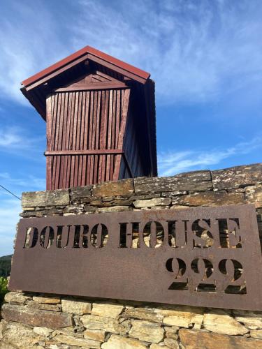 a sign for a davenport house on a stone wall at Douro House 222 in Castelo de Paiva