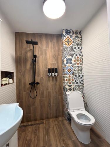 a bathroom with a toilet and a sink at Sinemorets Blue apartments in Sinemorets