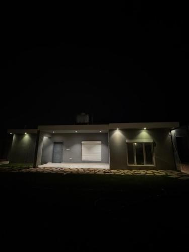 a house lit up at night with two windows at شاليه الماسيه خاص و مميز بأحدث المواصفات لنصنع الجمال بعينه in Riyadh