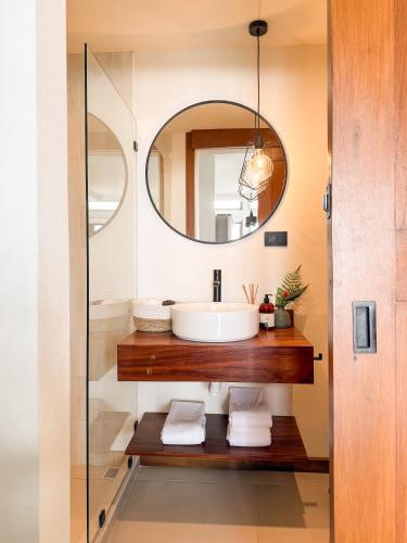 a bathroom with a sink and a mirror at Ananta Forest - Sunset & Gulf View - Glamping Dome and Mountain House in Monteverde Costa Rica