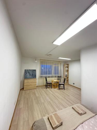 a room with a bed and a table and chairs at Palace of Culture Skyline in Warsaw