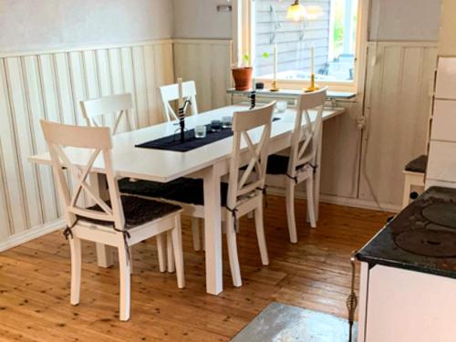 a white dining room table and chairs in a kitchen at 8 person holiday home in Ärla in Malmköping